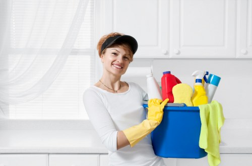 Carpet cleaning technician preparing equipment safely in a residential setting
